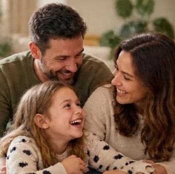 A laughing family together at home