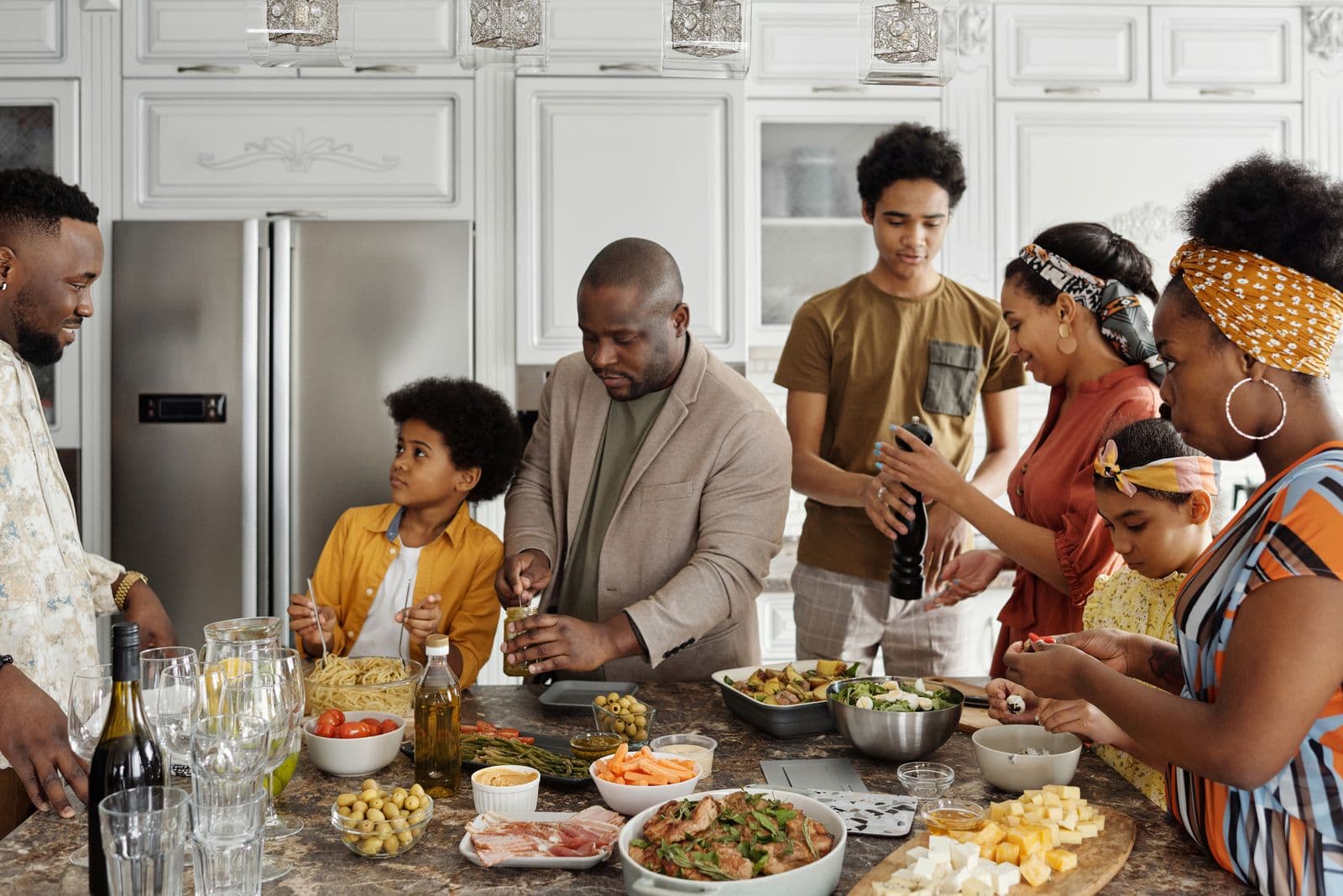 A family preparing food together in a sunlit kitchen