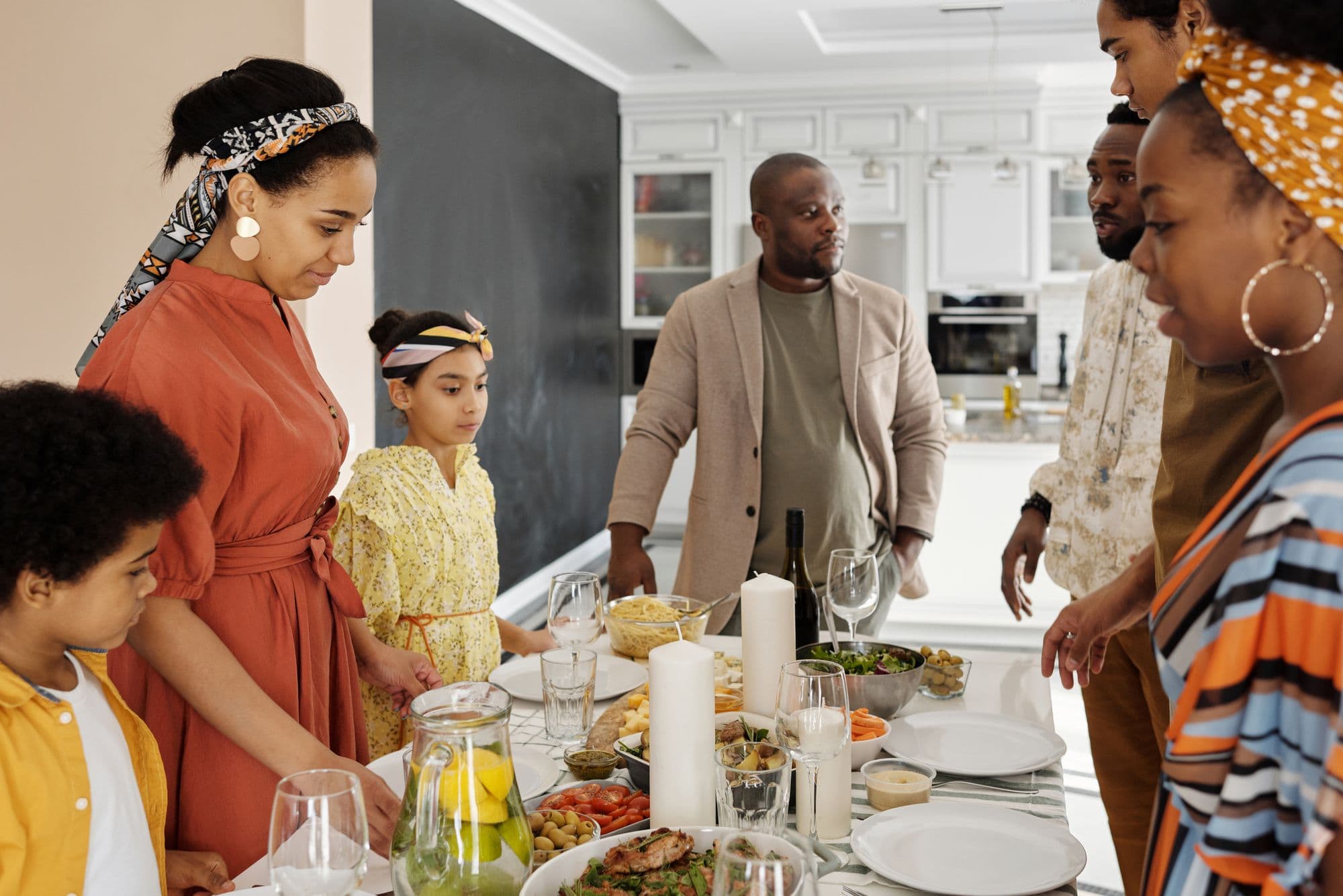 A family gathering food around a shared table
